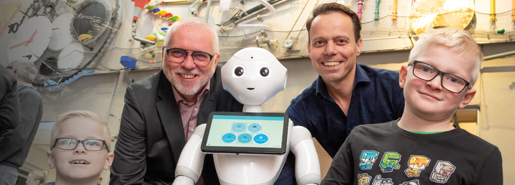 Gesellschaftliche Verantwortung für unsere Region ist Bestandteil unseres Handelns DOKOM21 Vertreter mit Kindern und einem Roboter